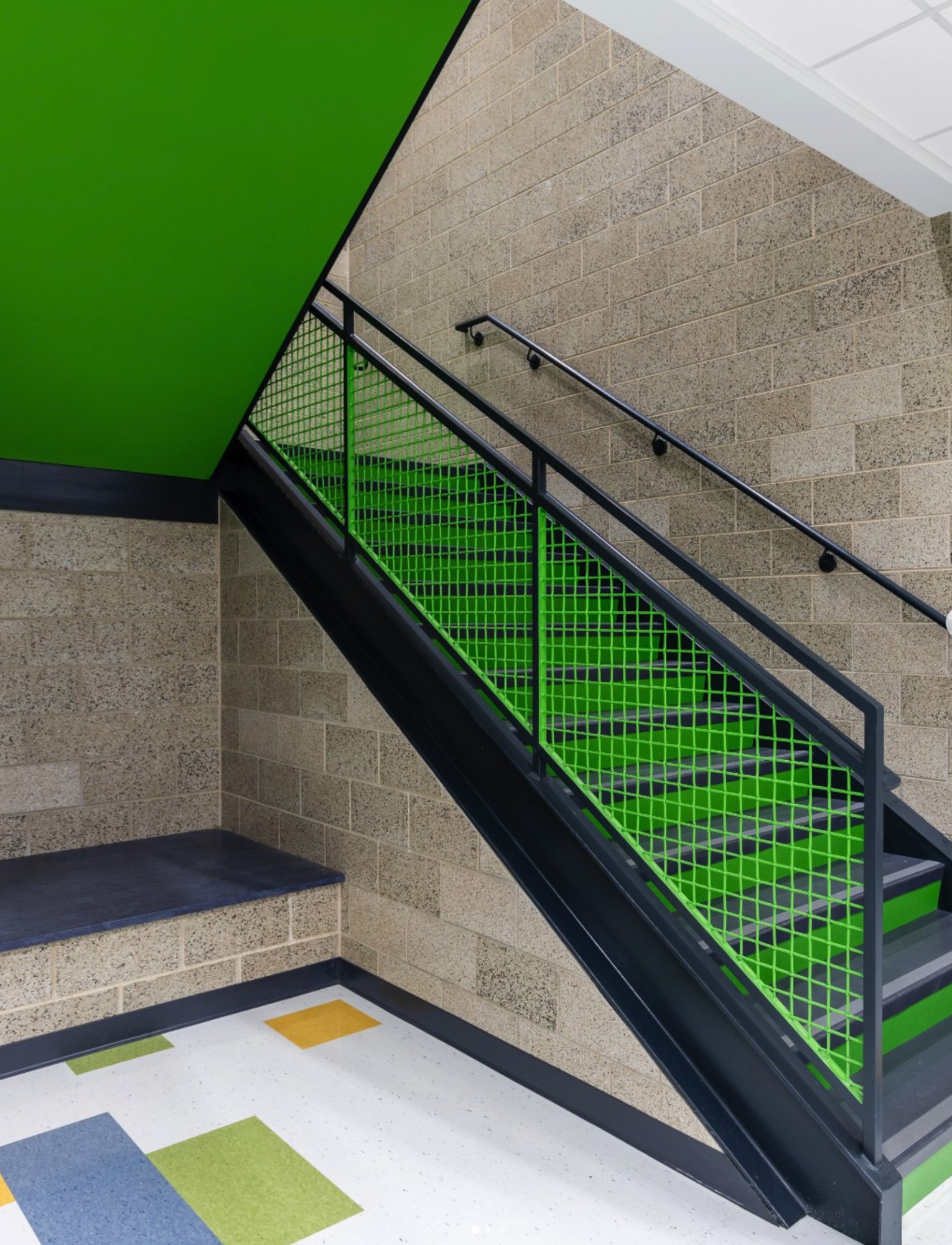 Green stairway with exposed concrete masonry walls